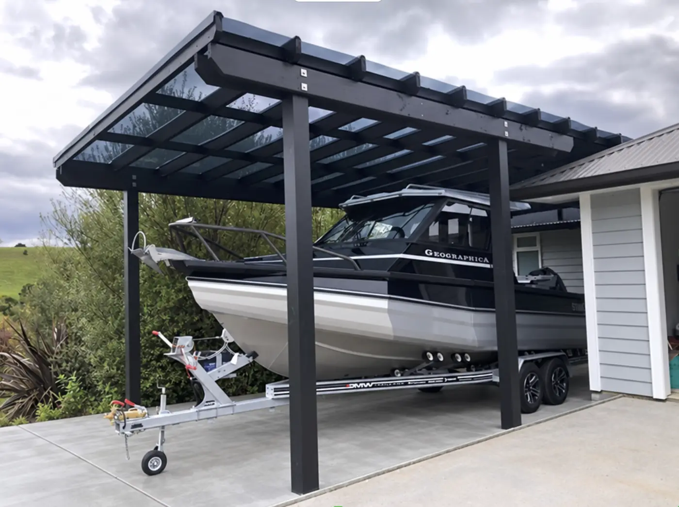 Carport sheltering a boat by Custom Decks and Fences